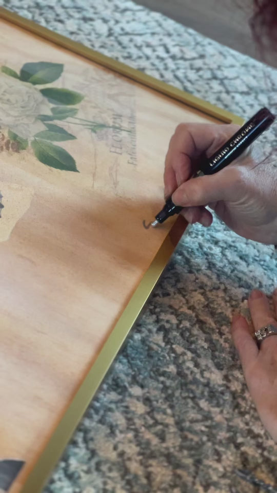 ShenShen210 signing airbrush and mixed media painting on wood featuring interlocked hands, teal butterfly, floral collage – contemporary fine art.